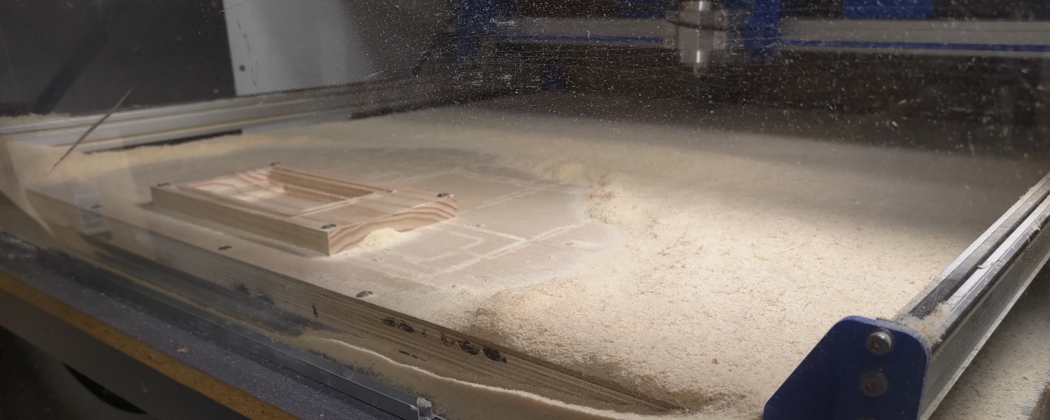 A CNC machine is carving a wooden object, showcasing precision in woodworking technology.